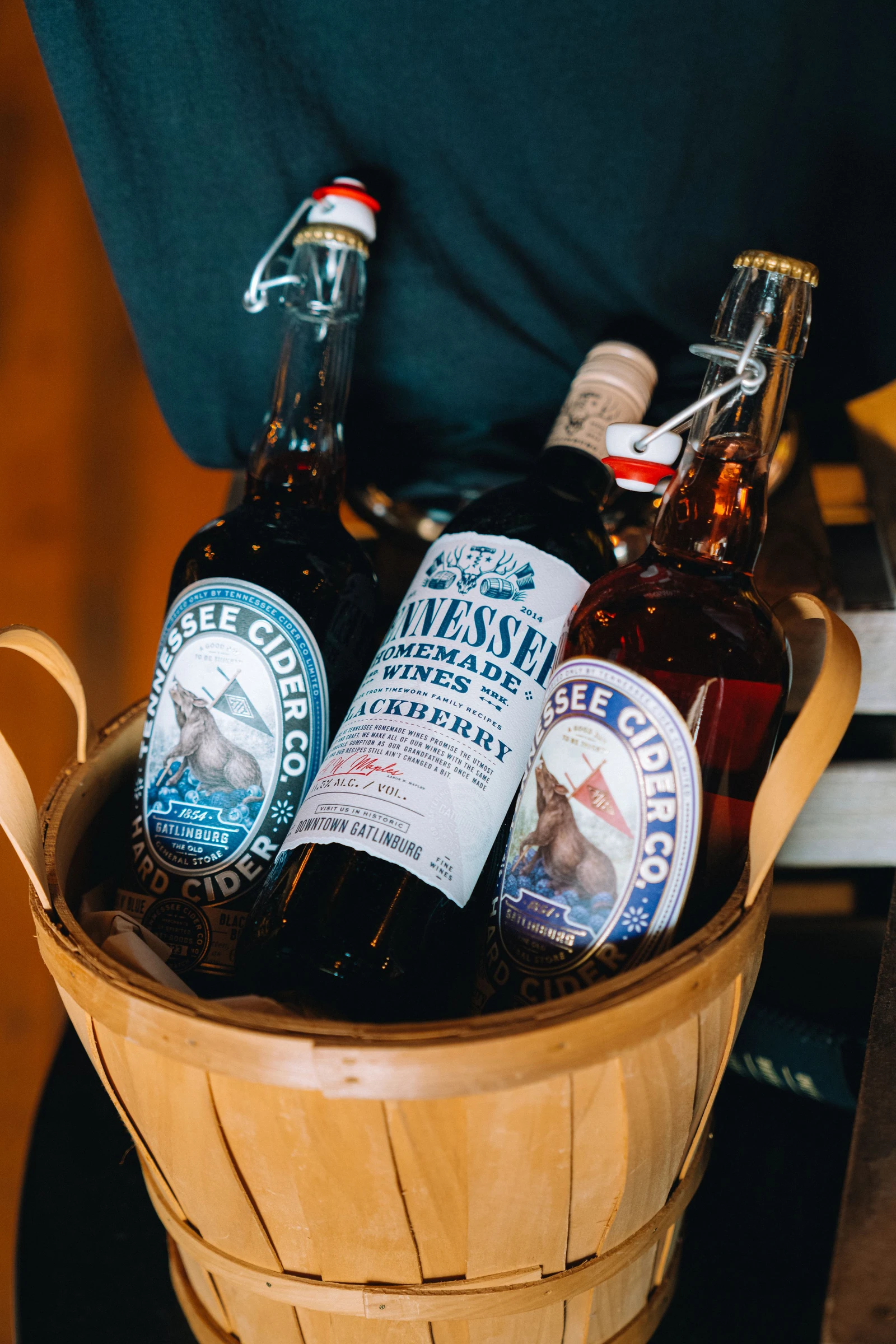 wine and cider bottles in a basket