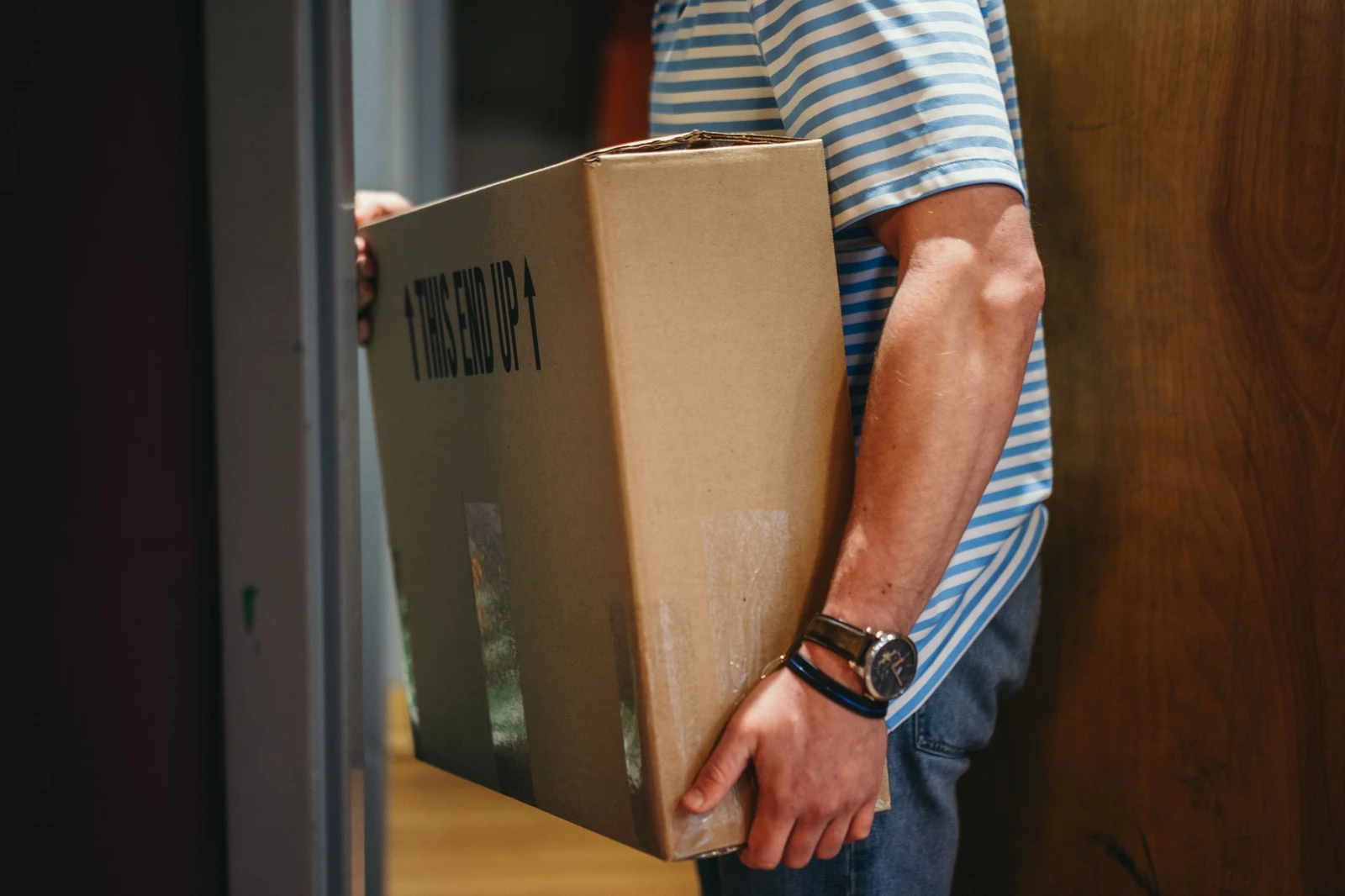 man carrying a box of wine